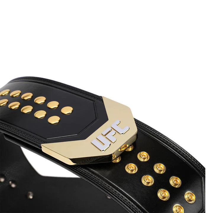 Close-up of the back strap and snap buttons on a UFC championship belt with black leather and gold details.