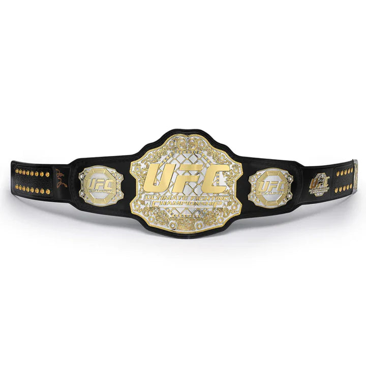 Front view of a gold UFC championship belt with a black leather strap on a white background.