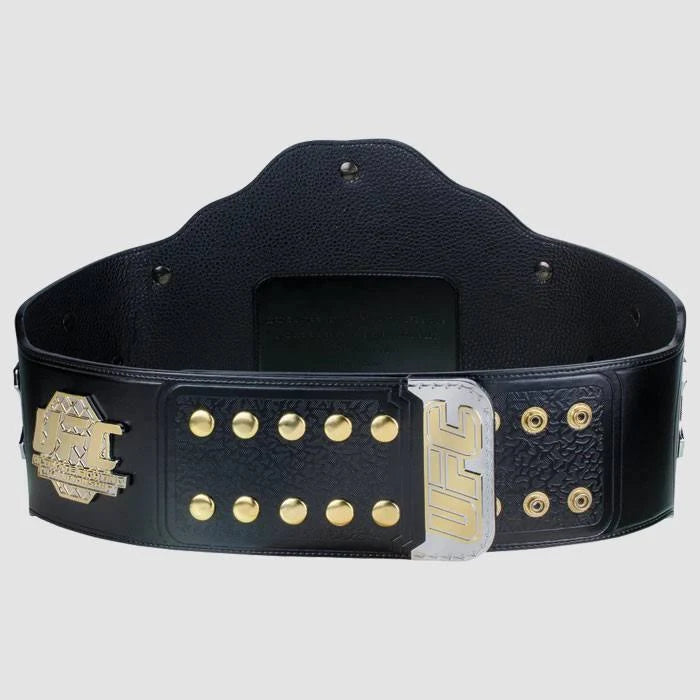 Inside view of a UFC championship belt showing the black leather strap with gold snap buttons and fastening details.