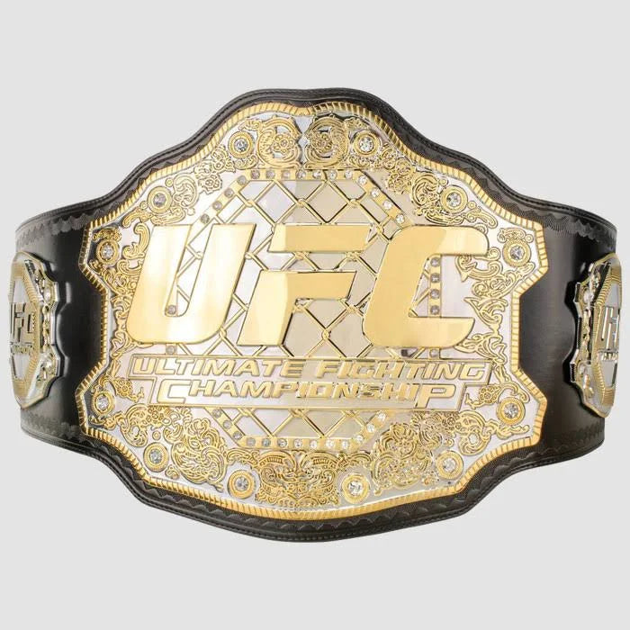 Front view of a gold UFC championship belt with a black leather strap and detailed engraved center plate.