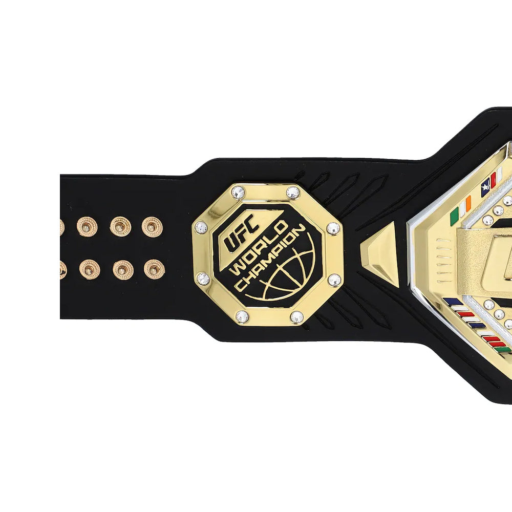 Close-up view of UFC legacy championship desktop belt featuring gold and black design with detailed emblem